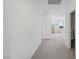 Carpeted hallway with neutral walls, leading to bright living spaces at 10172 Magnolia Creek St, Las Vegas, NV 89141