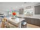 Modern kitchen with gray cabinets, white quartz counters and backyard view at 10172 Magnolia Creek St, Las Vegas, NV 89141