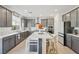 Spacious eat-in kitchen featuring gray cabinets, stainless steel appliances, and a center island at 10172 Magnolia Creek St, Las Vegas, NV 89141