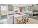 Modern kitchen featuring gray cabinets, a large island with seating, and stainless steel appliances at 10172 Magnolia Creek St, Las Vegas, NV 89141