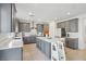 Modern kitchen with gray cabinets, white quartz island, and stainless steel appliances at 10172 Magnolia Creek St, Las Vegas, NV 89141