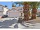 Two-story house with pink garage door and palm trees in front at 1712 Orchard Valley Dr, Las Vegas, NV 89142