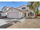 Two-story house with pink garage door, landscaping, and driveway at 1712 Orchard Valley Dr, Las Vegas, NV 89142