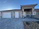 Two-car garage with modern exterior and stone accents at 3060 Spy Glass Ave, Pahrump, NV 89048