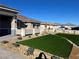 Landscaped front yard with artificial turf and drought-tolerant landscaping at 3060 Spy Glass Ave, Pahrump, NV 89048