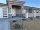 Modern home entrance with stone veneer, a covered entryway and walkway at 3060 Spy Glass Ave, Pahrump, NV 89048