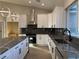 Modern kitchen featuring white shaker cabinets, dark marble countertops, and stainless steel appliances at 3060 Spy Glass Ave, Pahrump, NV 89048