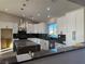 Modern kitchen with white cabinets, large island, and dark countertops at 3060 Spy Glass Ave, Pahrump, NV 89048