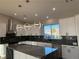 Modern kitchen with white cabinets, large island, and dark countertops at 3060 Spy Glass Ave, Pahrump, NV 89048