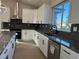 Modern kitchen with white cabinets, large island, and dark countertops at 3060 Spy Glass Ave, Pahrump, NV 89048