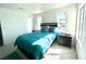 Bright bedroom with a teal comforter and two windows at 4428 W Lake Mead Blvd # 201, Las Vegas, NV 89108