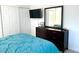 Bedroom with a teal comforter, dresser, and mounted TV at 4428 W Lake Mead Blvd # 201, Las Vegas, NV 89108