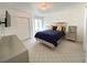 Bedroom with a navy blue comforter and a mounted TV at 4428 W Lake Mead Blvd # 201, Las Vegas, NV 89108