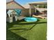 Backyard with artificial turf, playset, and covered patio at 7813 Blue Charm Ave, Las Vegas, NV 89149