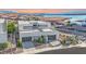 Contemporary home boasts clean lines, a flat roof, and an attached garage, nestled in a lakeside community at 28 Rainbow Point Pl, Henderson, NV 89011