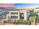 Modern two-story home featuring a balcony, large windows, and a beautifully landscaped yard, nestled within a vibrant community at 28 Rainbow Point Pl, Henderson, NV 89011