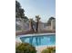 Community pool with palm trees and fence at 4613 Painted Cliffs Dr, Las Vegas, NV 89108