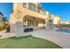Beautiful backyard showcasing a covered patio, outdoor seating, and a lush lawn at 7943 Sleeping Lily Dr, Las Vegas, NV 89178