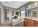 Bright primary bathroom with vanity, mirrors and a soaking tub with shower at 7943 Sleeping Lily Dr, Las Vegas, NV 89178