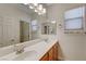 Bathroom features a long vanity with double sinks and large mirror at 7943 Sleeping Lily Dr, Las Vegas, NV 89178