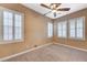 Cozy bedroom with carpet, ceiling fan, and shuttered windows, creating a comfortable and private retreat within the home at 7943 Sleeping Lily Dr, Las Vegas, NV 89178