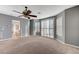 Spacious primary bedroom with carpet floors, gray accent walls and shuttered windows at 7943 Sleeping Lily Dr, Las Vegas, NV 89178