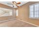 Serene bedroom featuring neutral carpet, staircase view, and window shutters, offering a comfortable and inviting space to relax at 7943 Sleeping Lily Dr, Las Vegas, NV 89178