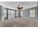 Spacious bedroom with carpet floors, gray accent walls and shuttered windows at 7943 Sleeping Lily Dr, Las Vegas, NV 89178