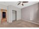 Bedroom with carpet, ceiling fan, closet, neutral walls, and access to adjoining rooms at 7943 Sleeping Lily Dr, Las Vegas, NV 89178