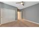 Spacious bedroom with neutral walls, carpet, closet with sliding doors, and ceiling fan at 7943 Sleeping Lily Dr, Las Vegas, NV 89178