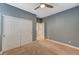 Neutral bedroom features carpet floors, gray accent walls and a ceiling fan at 7943 Sleeping Lily Dr, Las Vegas, NV 89178