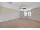 Large bonus room featuring neutral walls and carpet, ceiling fan, and shuttered windows at 7943 Sleeping Lily Dr, Las Vegas, NV 89178