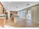 Bright kitchen features an island with granite countertop, light wood cabinets, and stainless steel appliances at 7943 Sleeping Lily Dr, Las Vegas, NV 89178