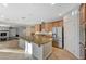 Bright, open kitchen with granite countertops, stainless steel appliances, and a large center island at 7943 Sleeping Lily Dr, Las Vegas, NV 89178