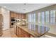 Spacious kitchen featuring a large island with sink, ample counter space, stainless steel appliances, and natural light at 7943 Sleeping Lily Dr, Las Vegas, NV 89178
