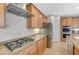 Close-up of the kitchen with stainless steel appliances, granite countertops, and a stylish range hood at 7943 Sleeping Lily Dr, Las Vegas, NV 89178