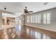 Bright living room with hardwood floors and plantation shutters leading to a kitchen at 7943 Sleeping Lily Dr, Las Vegas, NV 89178