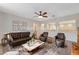 Staged living room featuring a leather sofa set and decorative cutouts to the bonus room at 7943 Sleeping Lily Dr, Las Vegas, NV 89178