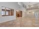 Open-concept living space with tile flooring, high ceilings, chandelier, and staircase, perfect for entertaining and comfortable living at 7943 Sleeping Lily Dr, Las Vegas, NV 89178