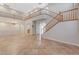 Spacious living room boasting soaring ceilings, tiled floors, and elegant staircase, offering a grand and open ambiance at 7943 Sleeping Lily Dr, Las Vegas, NV 89178