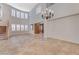 Spacious living area with tile flooring, staircase, and large windows, creating a bright and inviting atmosphere for everyday living at 7943 Sleeping Lily Dr, Las Vegas, NV 89178
