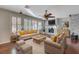 A staged living room features a stacked stone fireplace, ceiling fan, and plantation shutters at 7943 Sleeping Lily Dr, Las Vegas, NV 89178