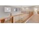 Second-story loft with wood railings overlooking the downstairs living area at 7943 Sleeping Lily Dr, Las Vegas, NV 89178