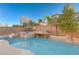 Inviting pool featuring a rock waterfall and lush landscaping at 7943 Sleeping Lily Dr, Las Vegas, NV 89178