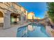 Beautiful backyard pool featuring a rock waterfall and mature landscaping at 7943 Sleeping Lily Dr, Las Vegas, NV 89178