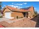 Tan one-story house with solar panels, tile roof, and a white garage door at 6370 Canyon Vista Ct, Las Vegas, NV 89156