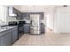 Modern kitchen with gray cabinets, stainless steel appliances, and tile flooring at 6370 Canyon Vista Ct, Las Vegas, NV 89156