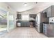 Modern kitchen with gray cabinets, stainless steel appliances, and tile flooring at 6370 Canyon Vista Ct, Las Vegas, NV 89156