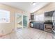 Eat-in kitchen with gray cabinets, stainless steel appliances, and tile flooring at 6370 Canyon Vista Ct, Las Vegas, NV 89156