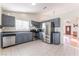 Modern kitchen with gray cabinets, stainless steel appliances, and tile flooring at 6370 Canyon Vista Ct, Las Vegas, NV 89156